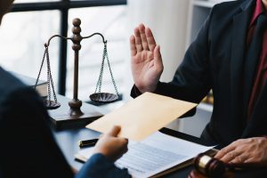 Lawyer refuse to accept bribes that are given in envelopes. To do illegal business, corruption in
